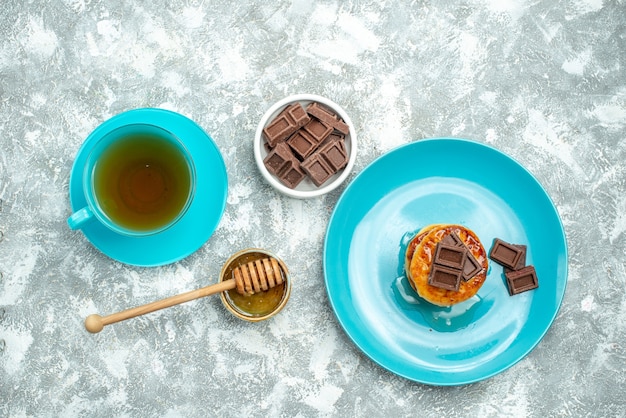 明るい背景にお茶とチョコレートのカップとおいしいマフィンの上面図