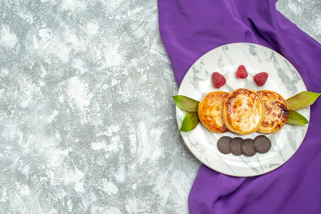 Top view delicious muffins with honey and choco biscuits on light background