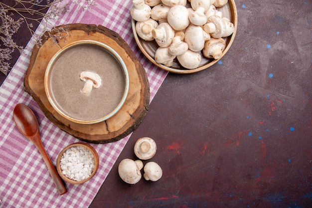 Top view delicious mushroom soup with mushrooms on dark space