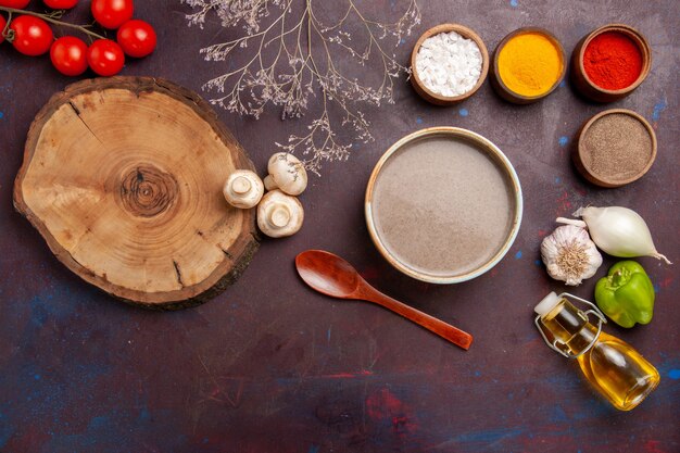 Top view delicious mushroom soup with seasonings on the dark space