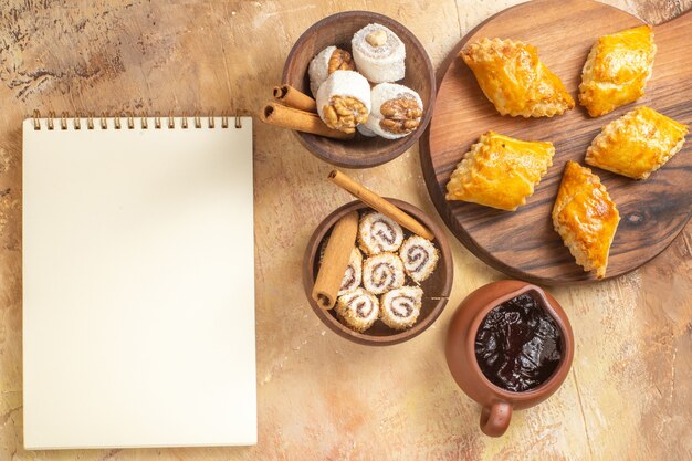 Top view of delicious nut cakes with confitures on wooden surface