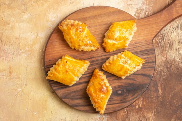 Top view of delicious nut cakes on wooden surface