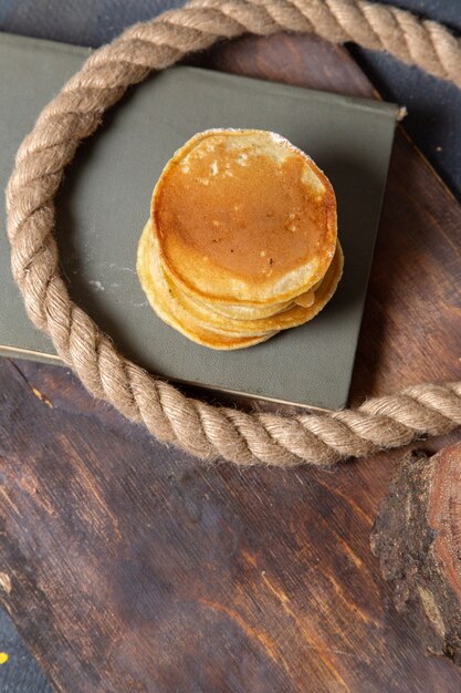 Top view delicious pancakes with ropes on the wooden desk food meal breakfast photo