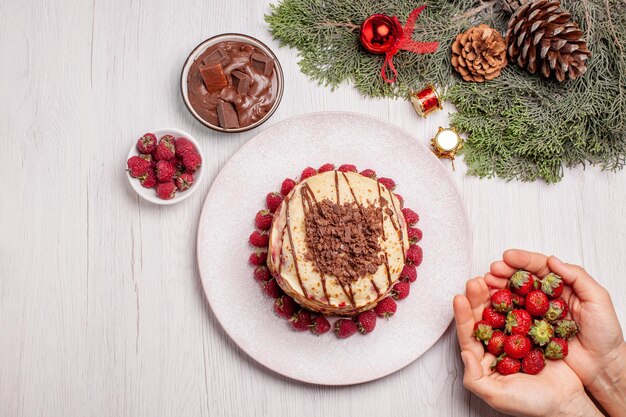 Top view delicious pancakes with strawberries on a white desk berry pie fruit sweet cake biscuit