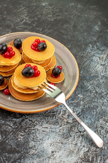 Top view on delicious pancakes with various ingredients