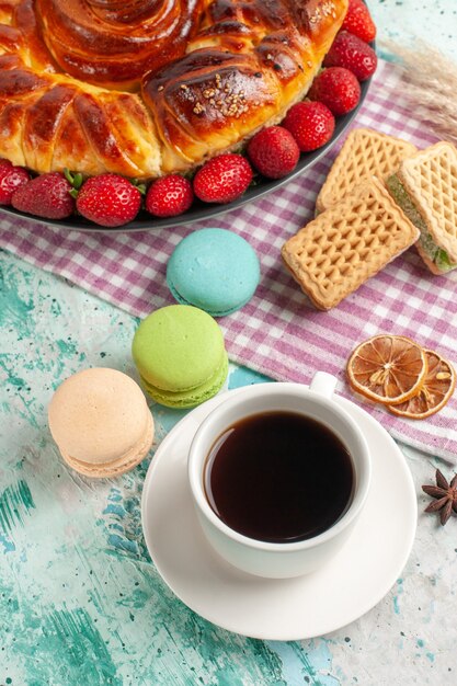 Top view delicious pie with cup of tea and fresh red strawberries on blue surface