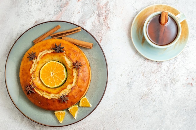 Top view delicious pie with cup of tea on white background fruits sweet nut cake pie biscuit