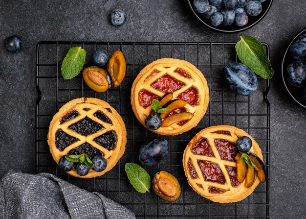 Top view of delicious pies with plums