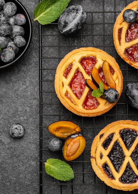 Top view of delicious pies with plums