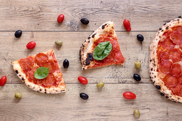 Top view delicious pizza on wooden background