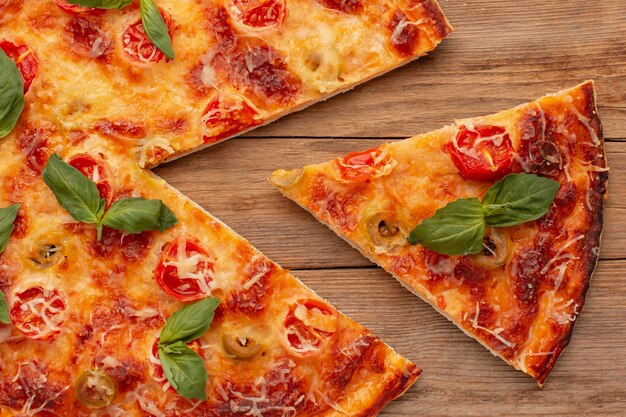 Top view delicious pizza on wooden background