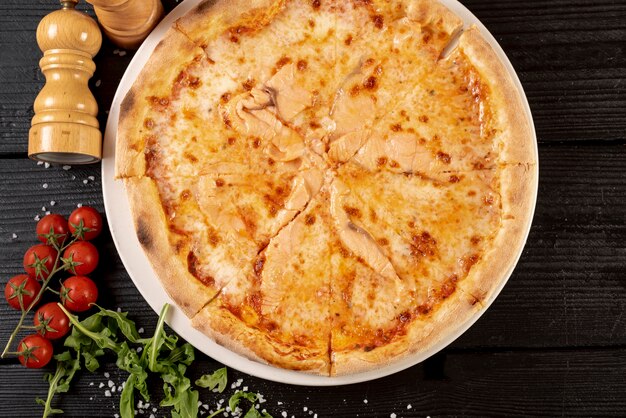 Top view of delicious pizza on wooden table