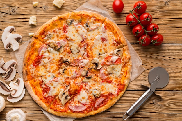 Top view of delicious pizza on wooden table