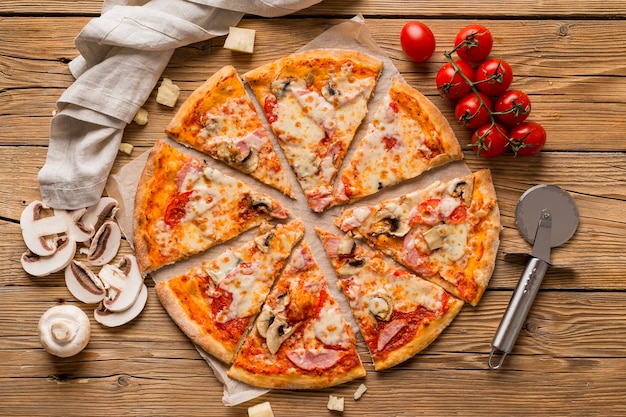 Top view of delicious pizza on wooden table