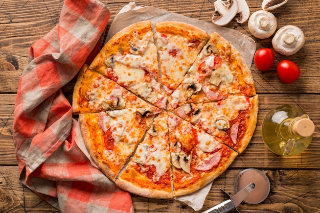 Top view of delicious pizza on wooden table