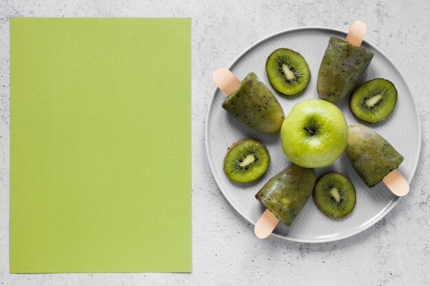 Top view of delicious popsicles with apples and copy space