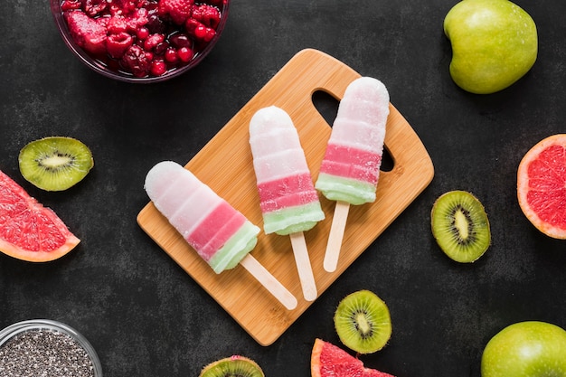 Top view of delicious popsicles with fruit