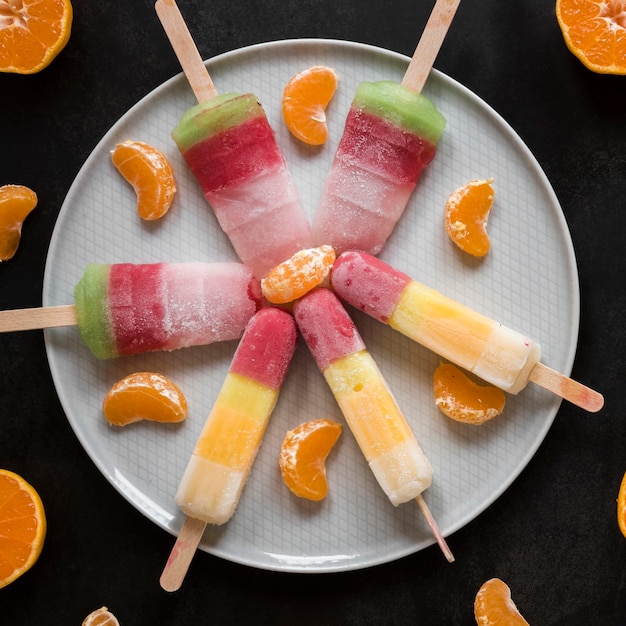 Top view of delicious popsicles with orange