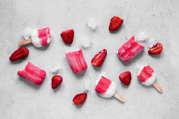 Top view of delicious popsicles with strawberries
