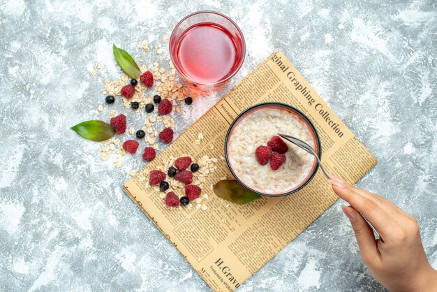 Top view delicious porridge with raspberries on light background