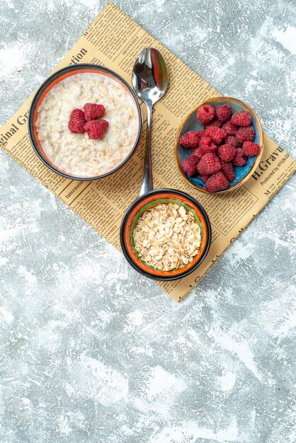 Top view delicious porridge with raspberries on light background