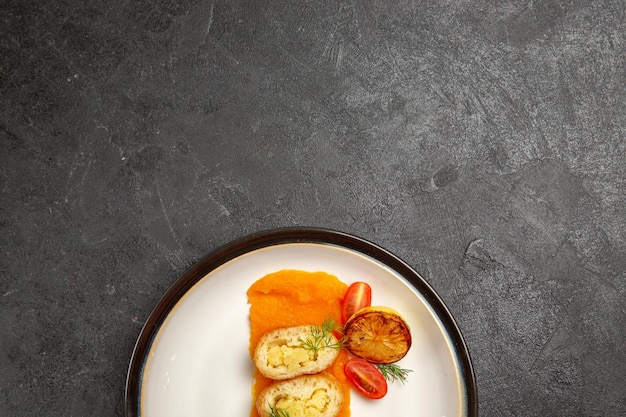 Top view delicious potato pies with pumpkin inside plate on dark-grey background oven bake color dish dinner slice