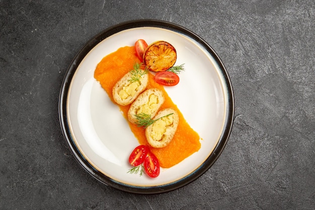 Top view delicious potato pies with pumpkin inside plate on grey background oven bake color dish dinner slice