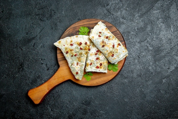 Top view delicious qutabs rolled green filled dough slices on grey space