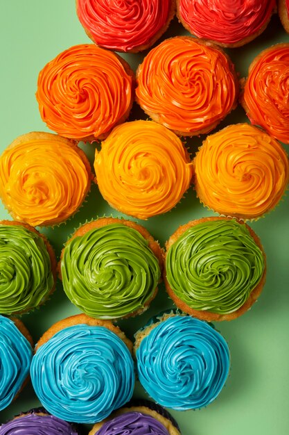 Top view delicious rainbow cupcake glaze still life