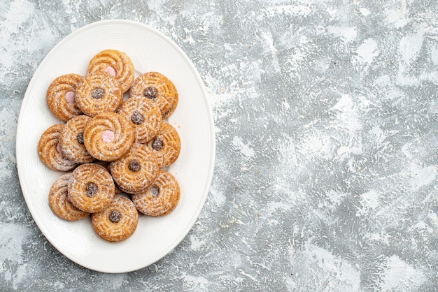 Top view delicious round biscuits inside plate on a white space