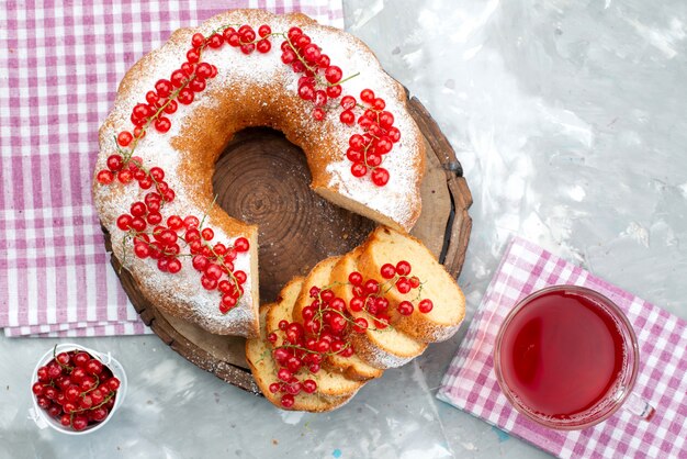 A top view delicious round cake with fresh red cranberries and cranberry juice on the white desk cake biscuit berry sugar