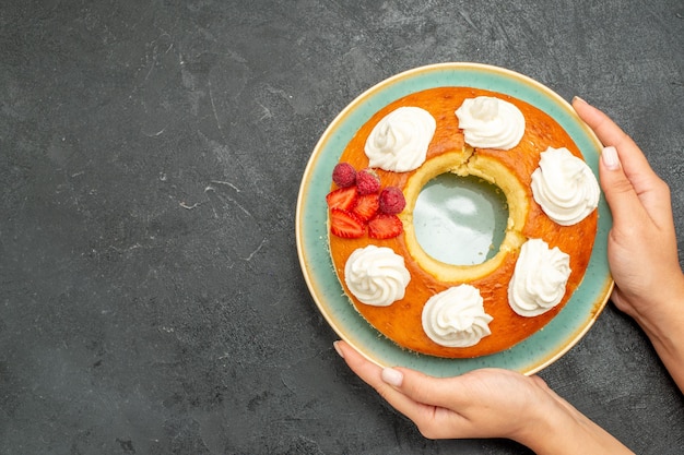 Top view delicious round pie with fruits and cream on dark background sugar cookie biscuit cake pie sweet