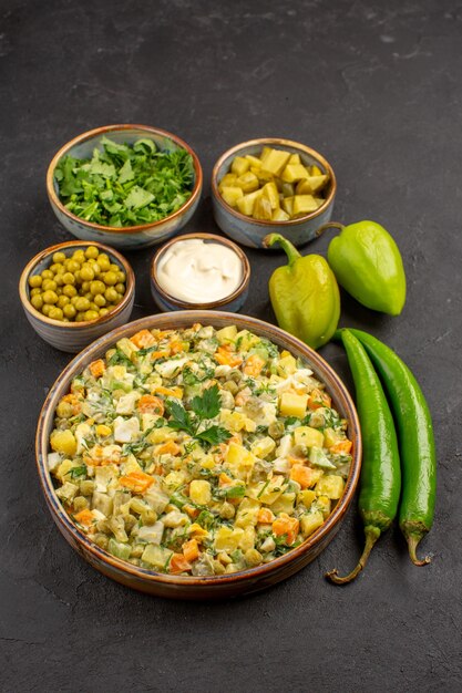 Top view of delicious salad with ingredients on a dark surface