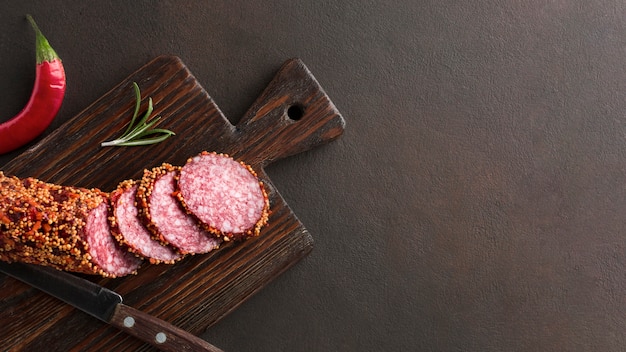 Top view delicious salami on the table with copy space