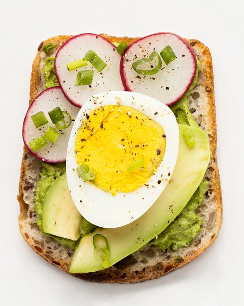 Top view of delicious sandwich with egg and avocado