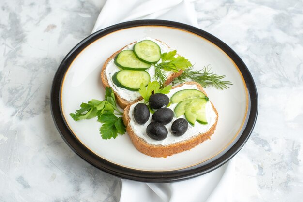 Top view delicious sandwiches with cucumbers and olives inside plate white background health horizontal food meal bread lunch toast burgers
