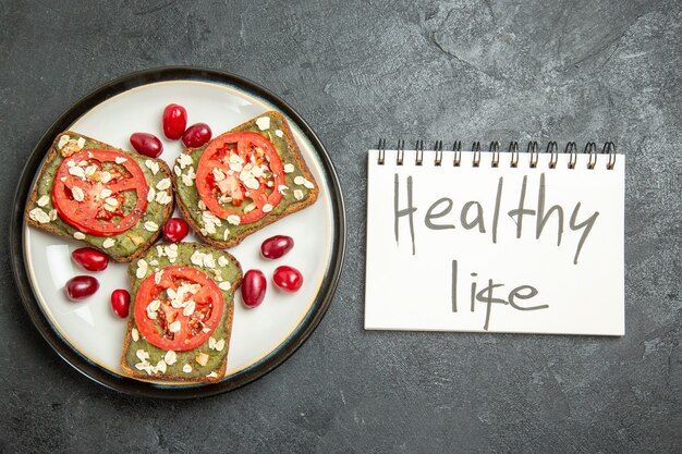 Top view delicious sandwiches with sliced tomatoes and healthy life writing on grey surface snack bun burger sandwich bread