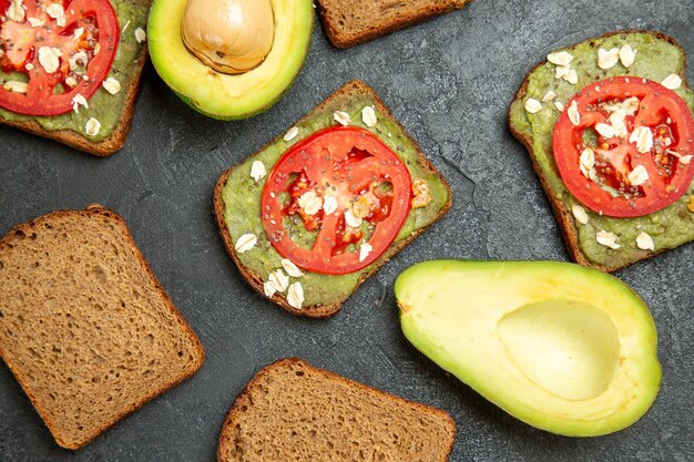 Top view delicious sandwiches with wassabi and red tomatoes on grey surface snack meal burger sandwich bread