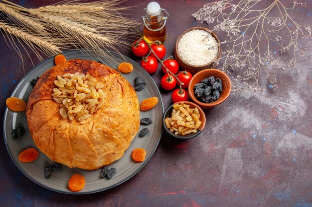 Top view delicious shakh plov cooked rice meal with raisins and tomatoes on the dark background meal dough cooking rice dinner