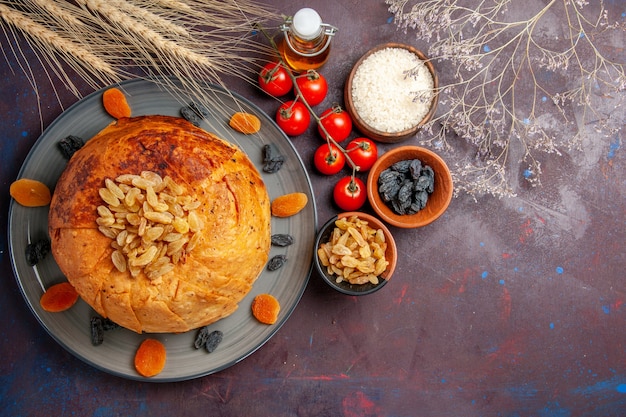 Top view delicious shakh plov cooked rice meal with raisins and tomatoes on dark background meal dough rice dinner