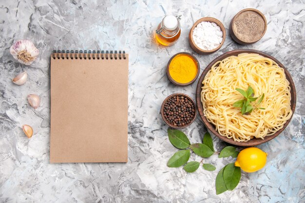 Top view delicious spaghetti with seasonings on white table meal dish pasta