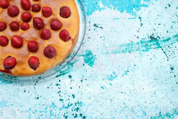 Top view of delicious strawberry cake round shaped with fruits on top and inside on bright desk, cake dough sweet biscuit sugar