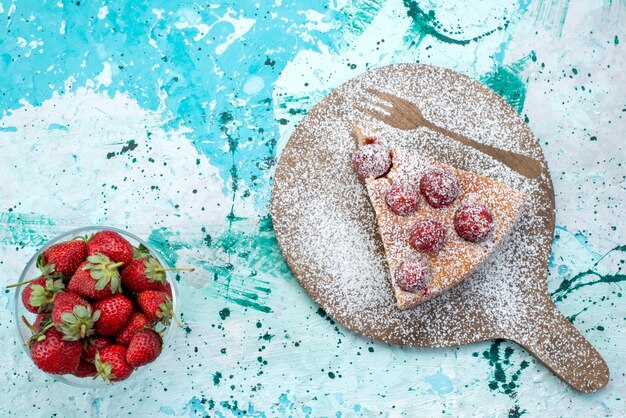 Top view of delicious strawberry cake sliced delicious cake sugar powdered on bright-blue desk, berry cake sweet bake dough