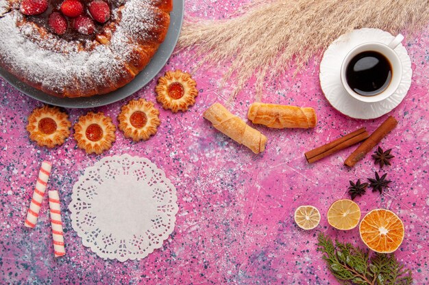 Top view delicious strawberry cake sugar powdered cake with cookies bagels and cup of tea on pink background cake sweet sugar cookies pie