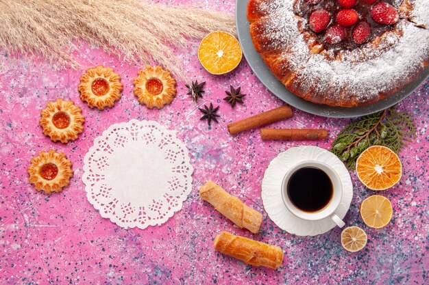 Top view delicious strawberry cake sugar powdered cake with cookies and cup of tea on the pink background cake sweet sugar biscuit cookies pie