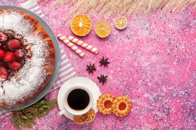 Top view delicious strawberry cake sugar powdered with cookies and tea on light-pink background cake sweet sugar biscuit cookies tea