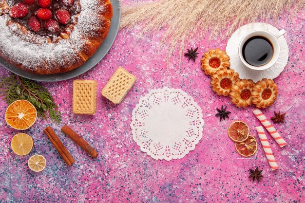 Top view delicious strawberry cake with cookies and cup of tea on light pink background cake bake sweet sugar biscuit cookie pie