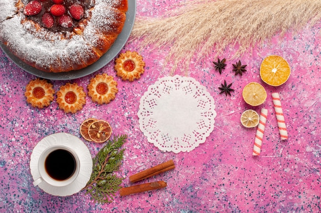 Top view delicious strawberry cake with cookies and cup of tea on the light pink background cake sweet sugar cookies pie