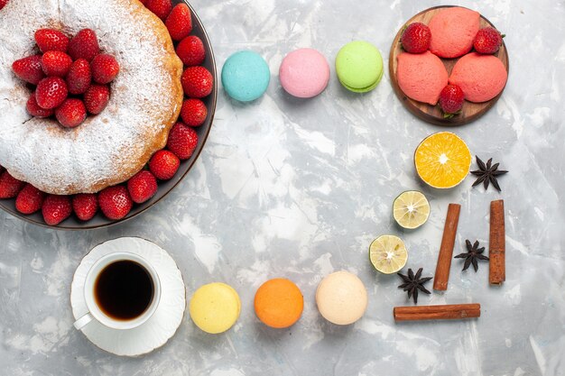 Top view delicious strawberry pie with tea and fruits on white