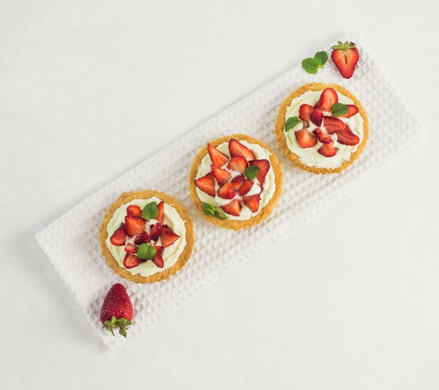 Free photo top view delicious strawberry tart diagonal